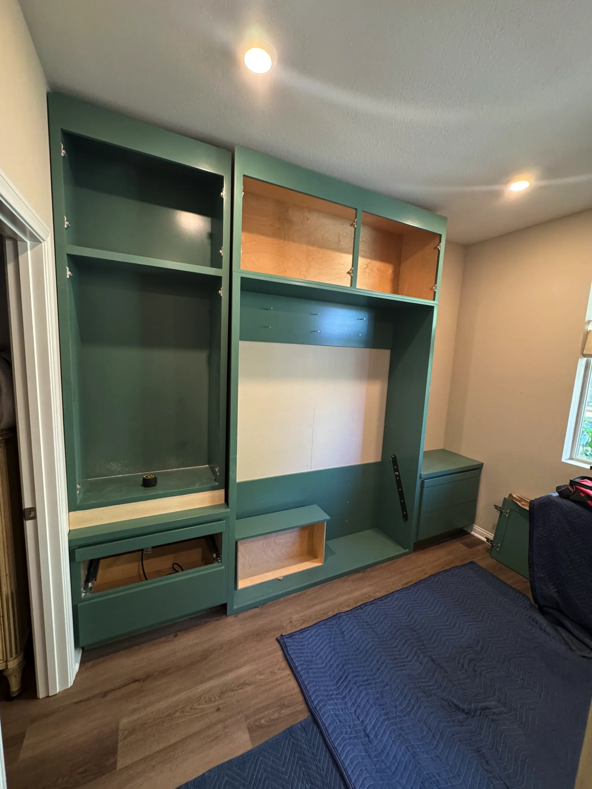 custom storage solution with a fold-down wall bed for a flexible guest room