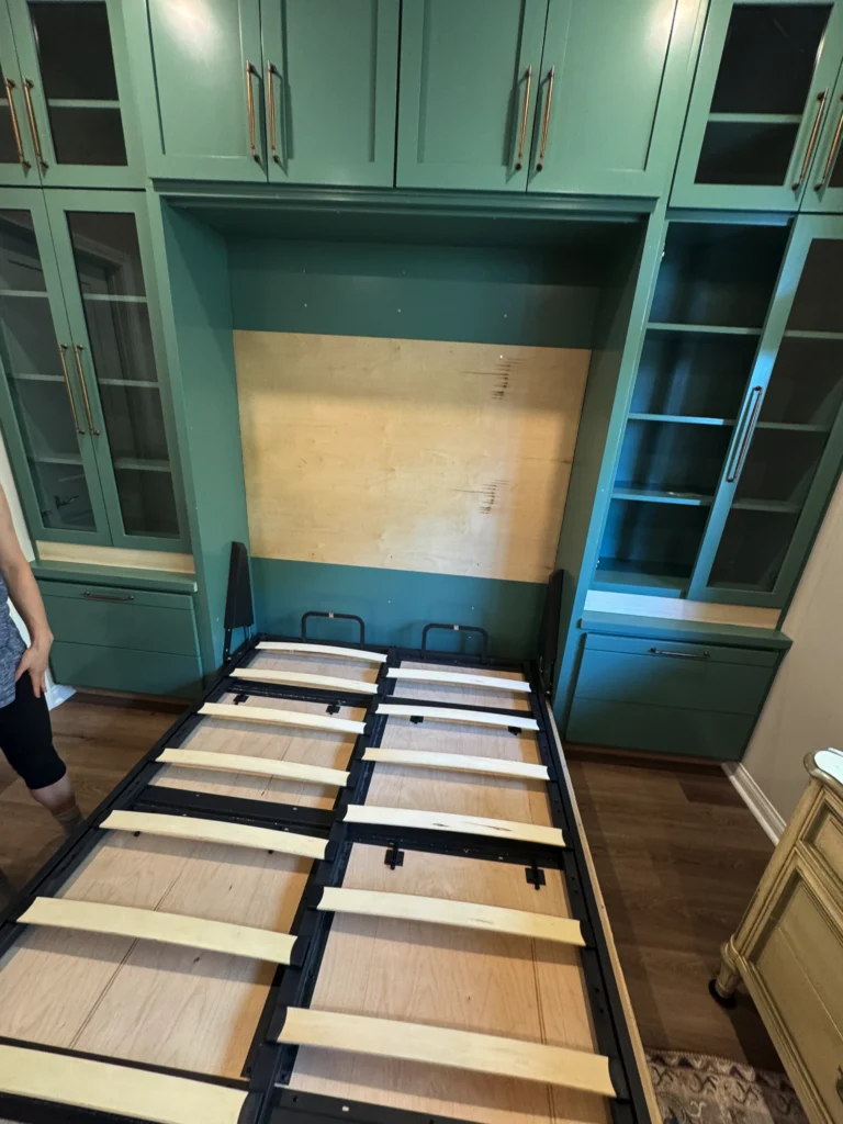 dusty green shaker style murphy bed with glass display cabinets and brass hardware