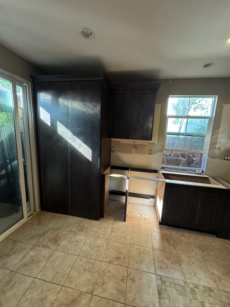 dark wood raised panel cabinets with quartz slab backsplash
