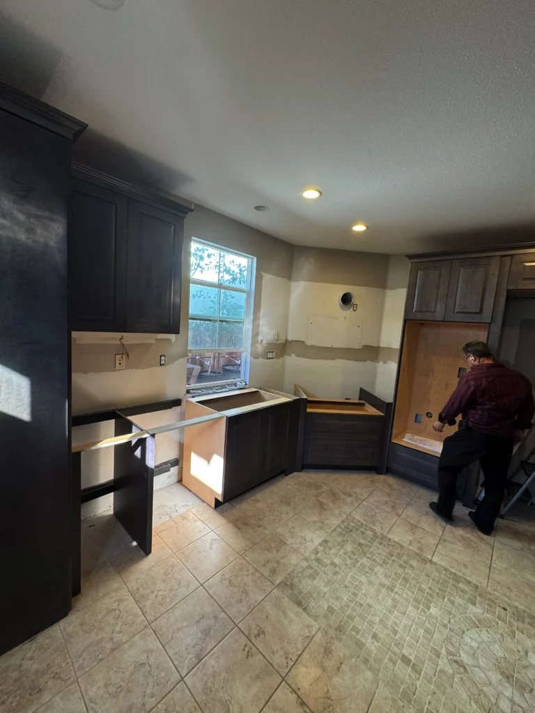 dark wood raised panel cabinets with quartz slab backsplash