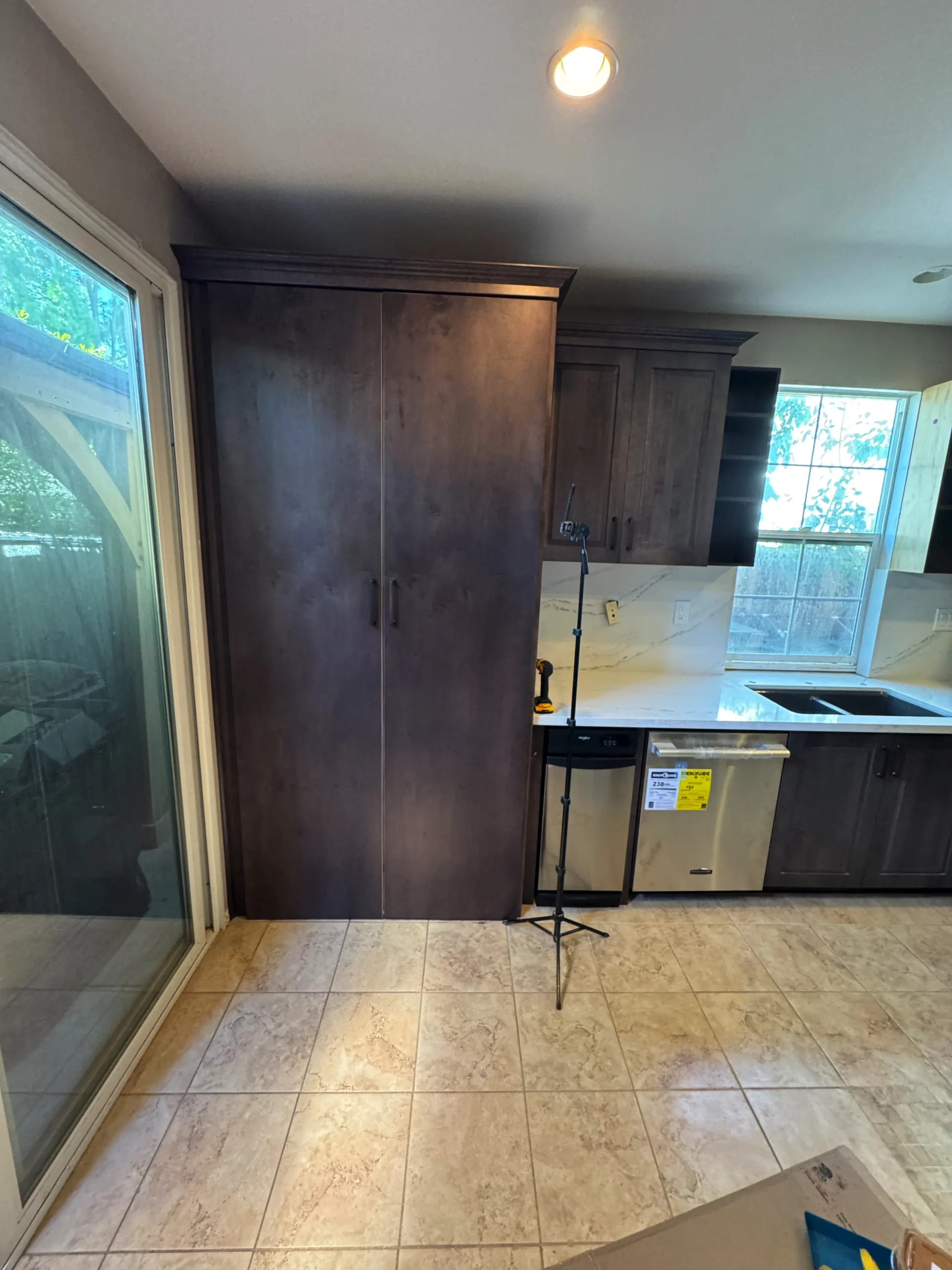 dark wood raised panel cabinets with quartz slab backsplash