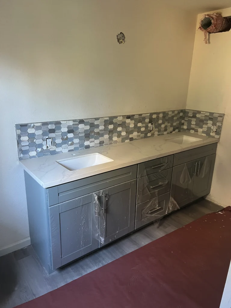 light grey-blue shaker cabinets with white quartz countertops
