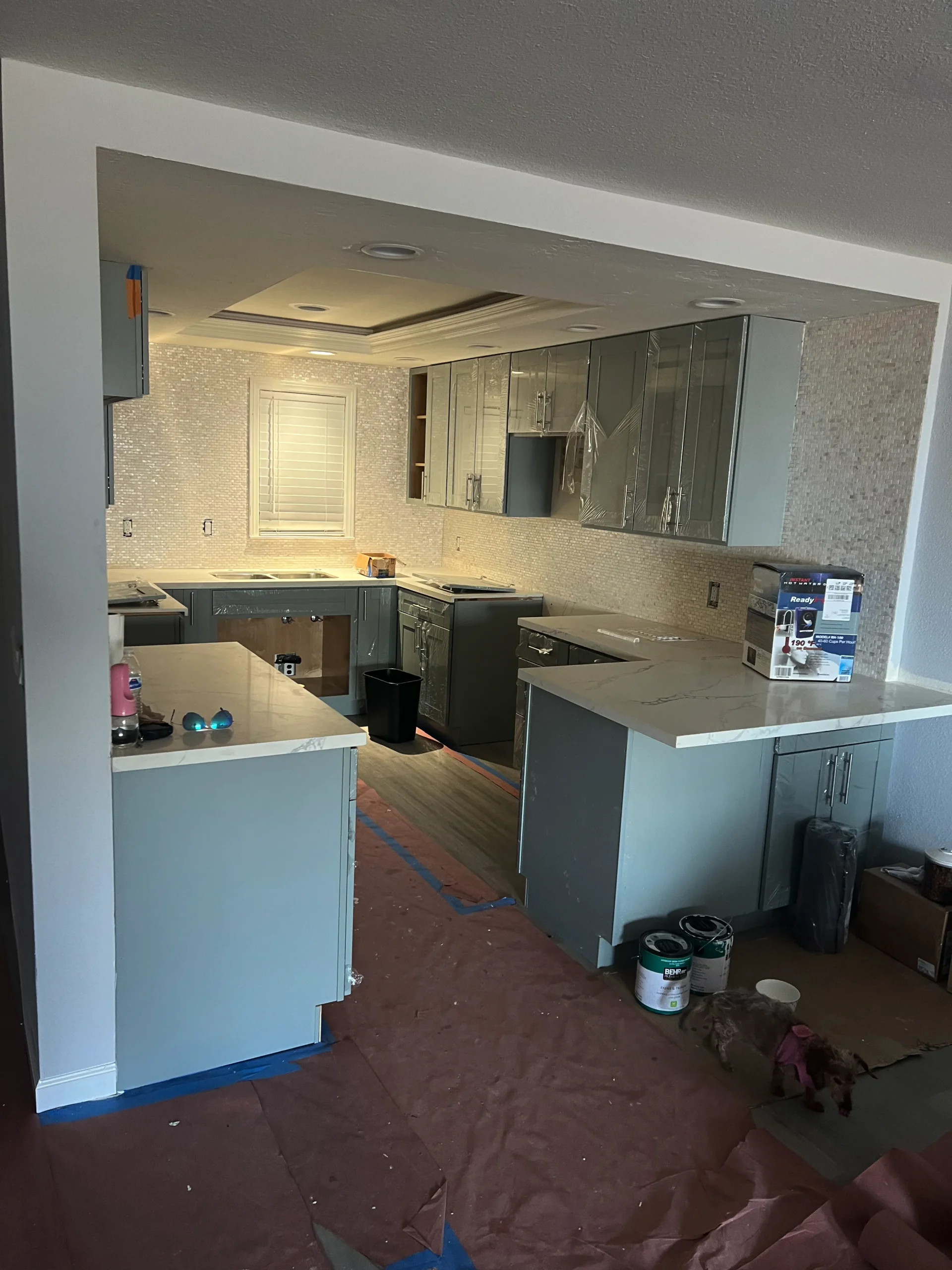light grey-blue shaker cabinets with white quartz countertops