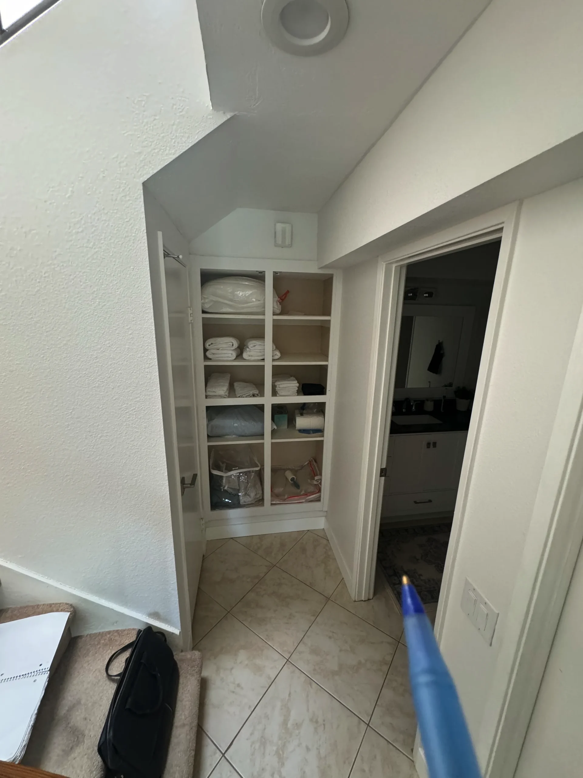 transforming a cluttered storage nook into a concealed hallway cabinet