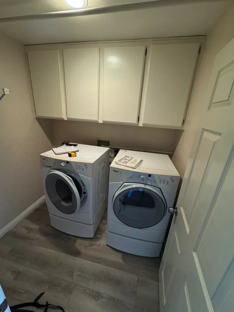 Encinitas laundry room with a deep utility sink and a floating wood shelf