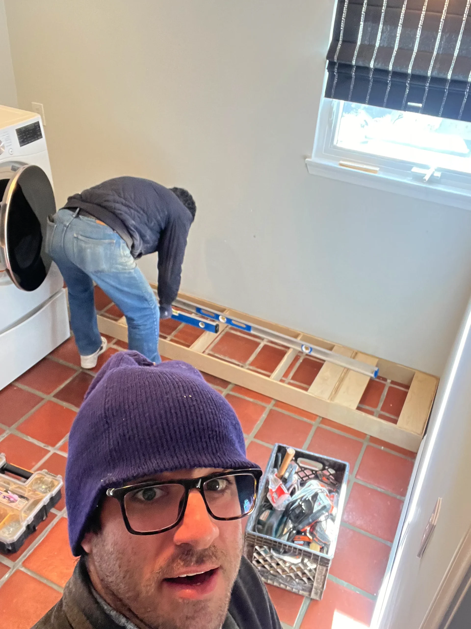 Carlsbad laundry room featuring floating shelves and a walnut butcher block