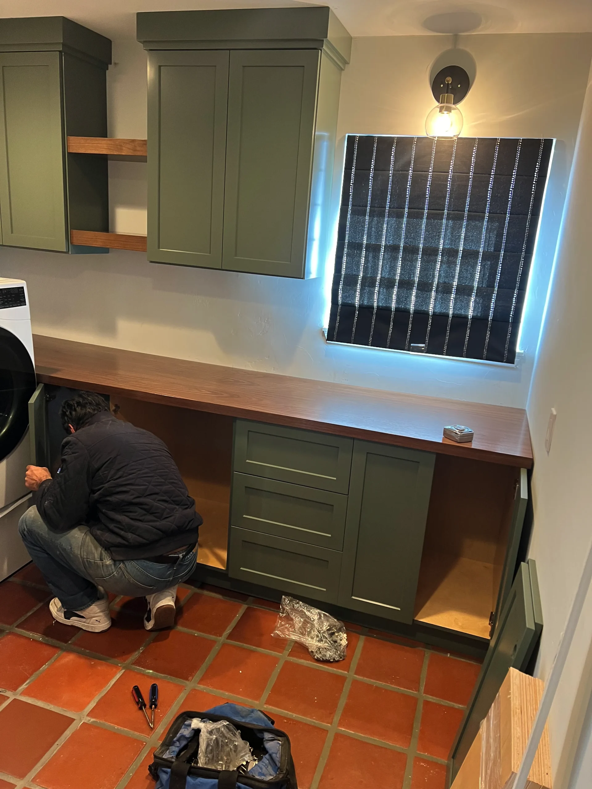 olive green shaker cabinets with a natural wood countertop