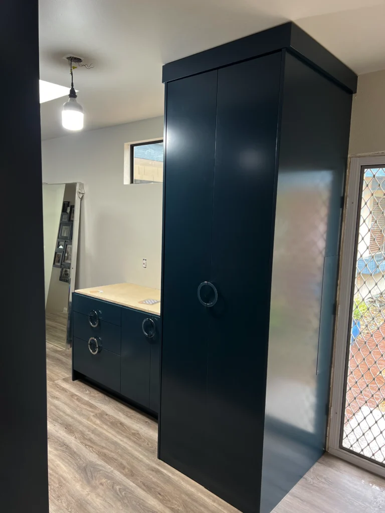 custom laundry room cabinets San Marcos with hidden washer dryer