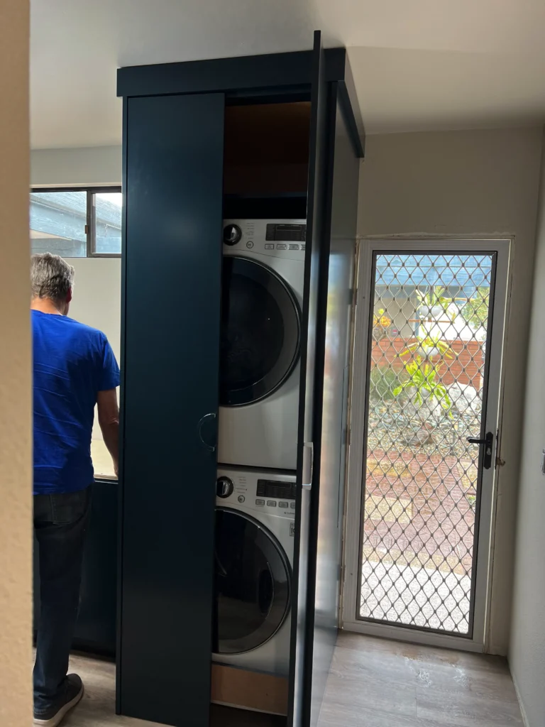 custom laundry room cabinets San Marcos with hidden washer dryer