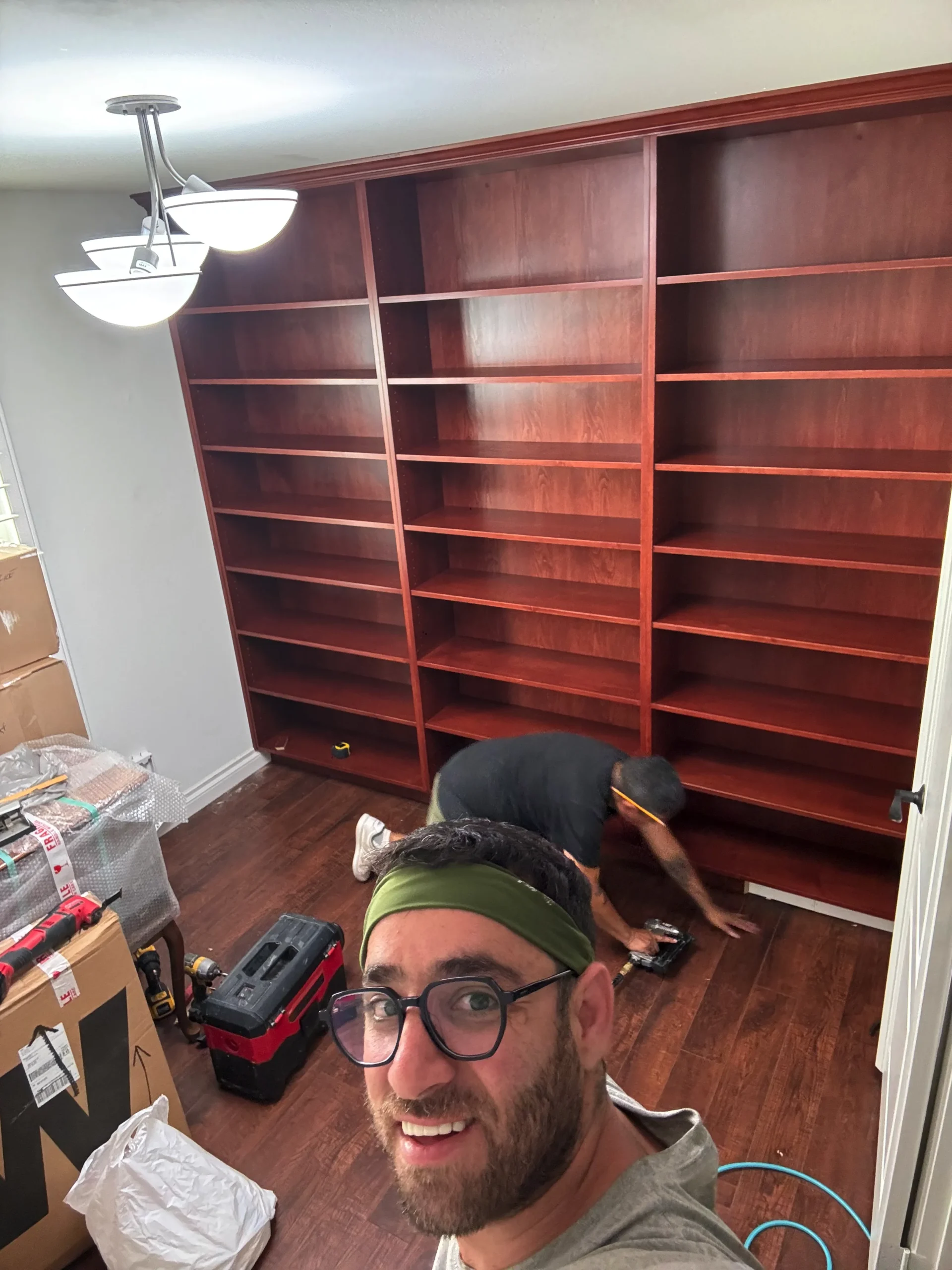 traditional home library with adjustable shelves and crown molding