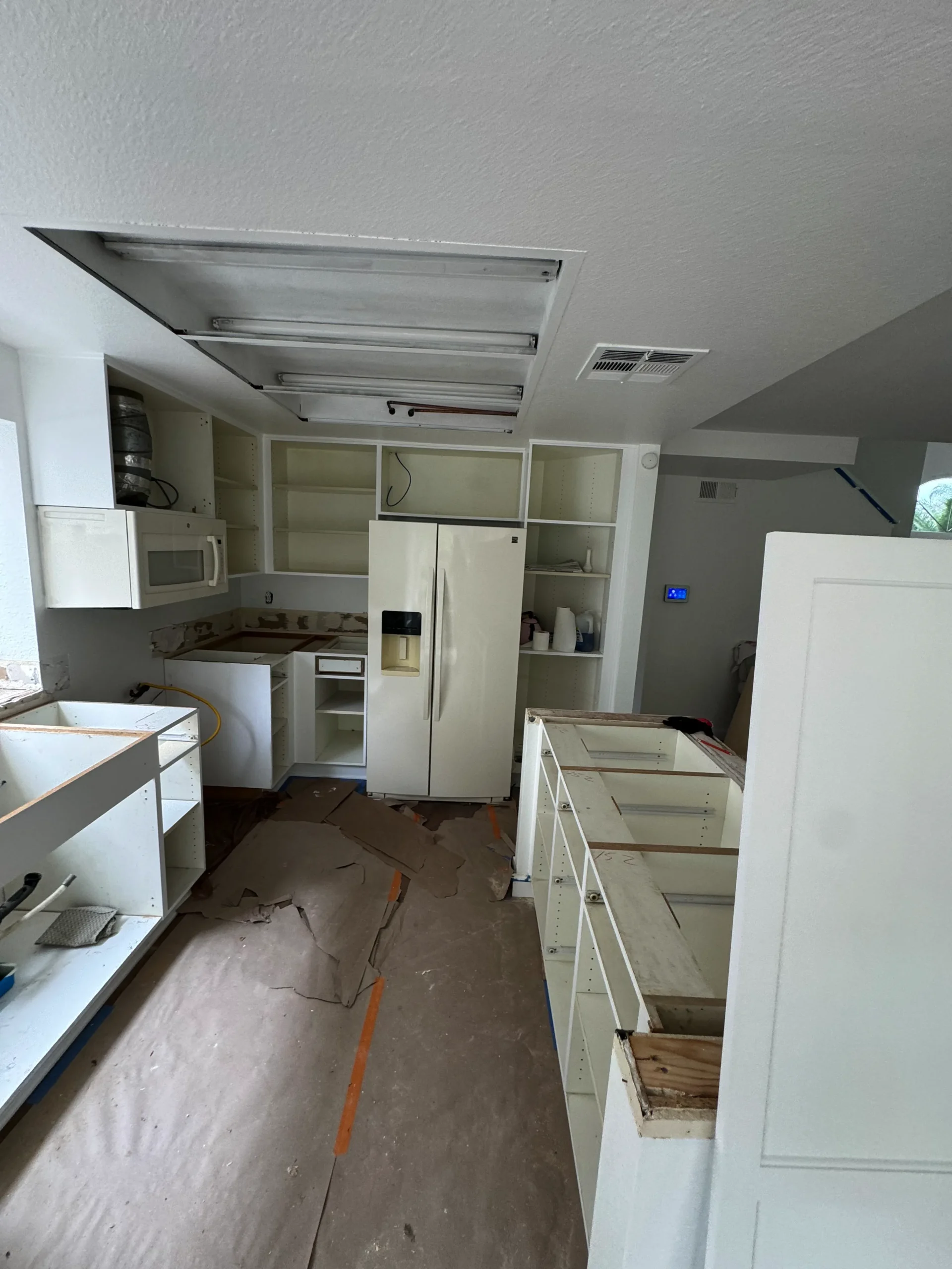 before and after photos of a white shaker cabinet update