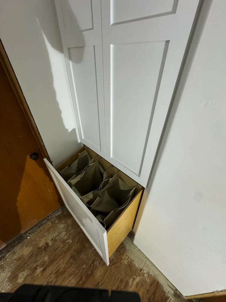 tall and narrow linen closet custom-built between two doors