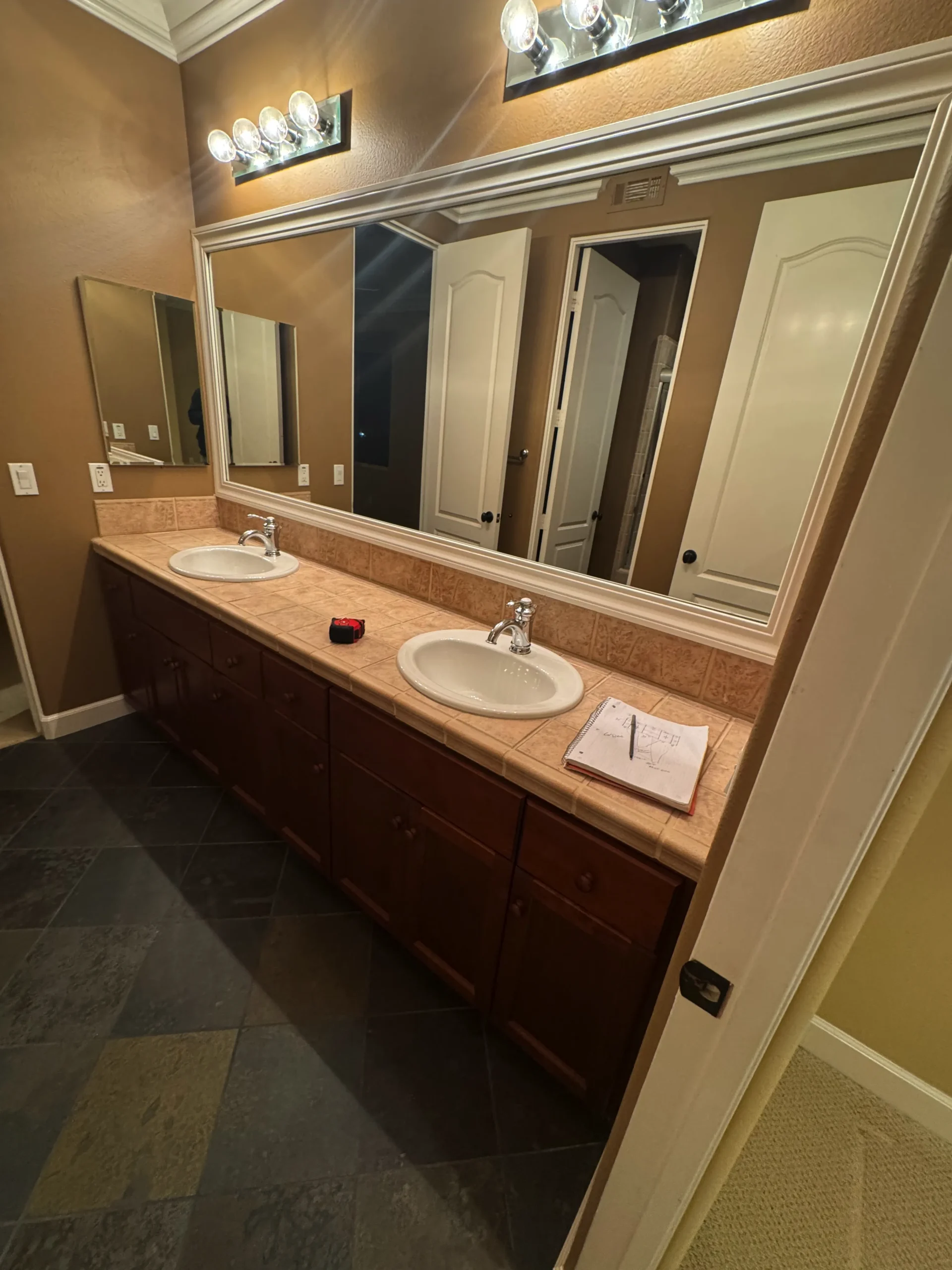 master bathroom remodel with a stained wood double vanity