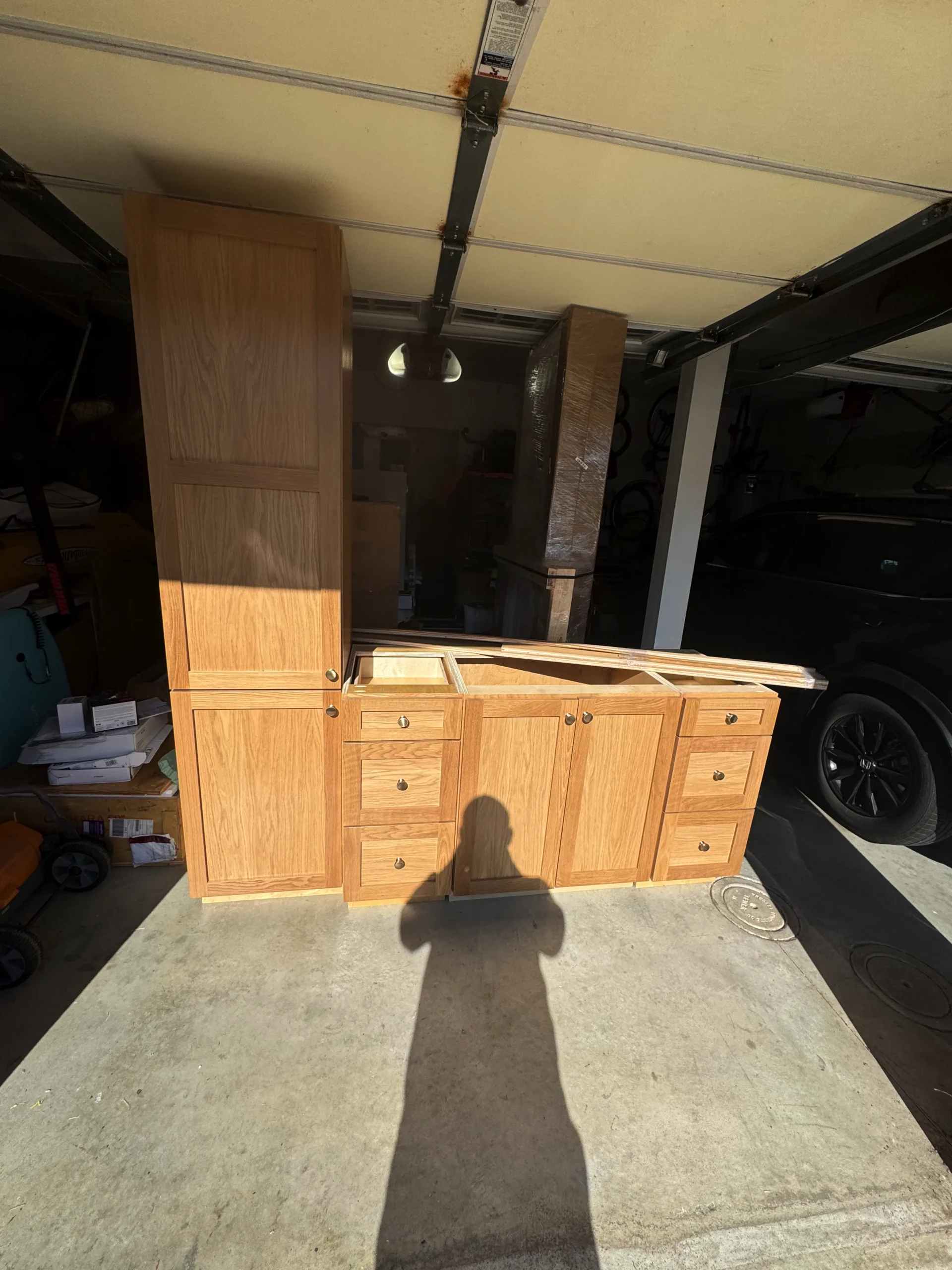 natural wood double vanity with an integrated linen tower