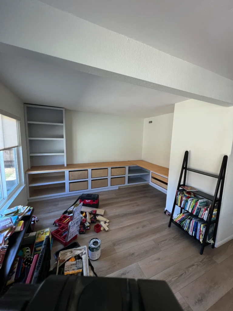 light grey shaker cabinets with a white oak desktop and brass hardware