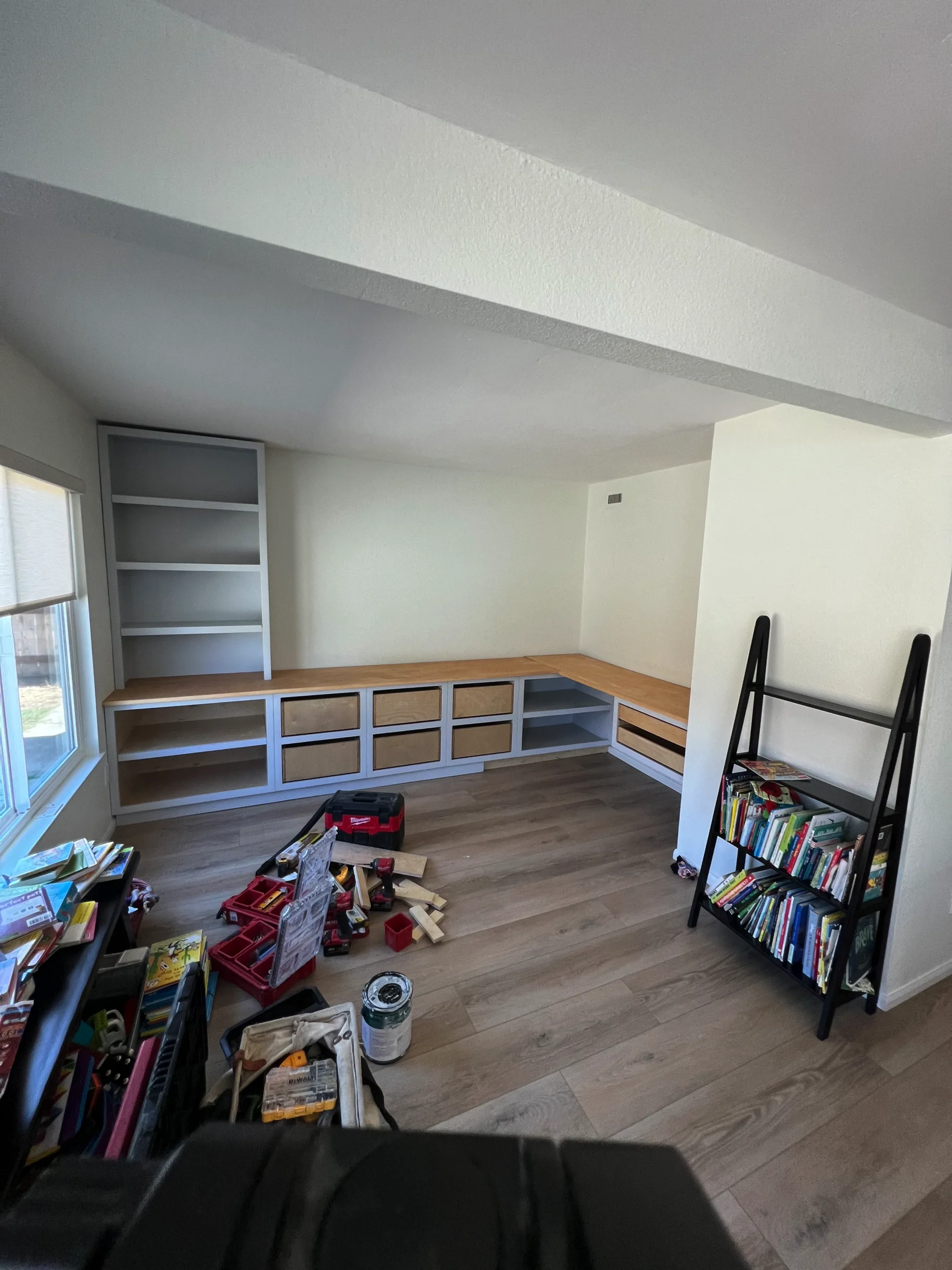 light grey shaker cabinets with a white oak desktop and brass hardware