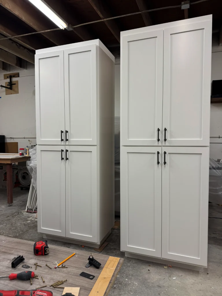 floor-to-ceiling white shaker style storage cabinets