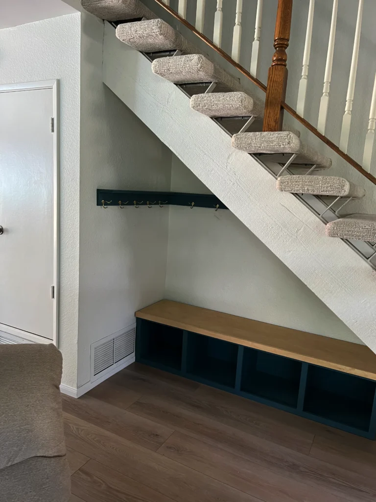 light grey shaker cabinets with a white oak desktop and brass hardware