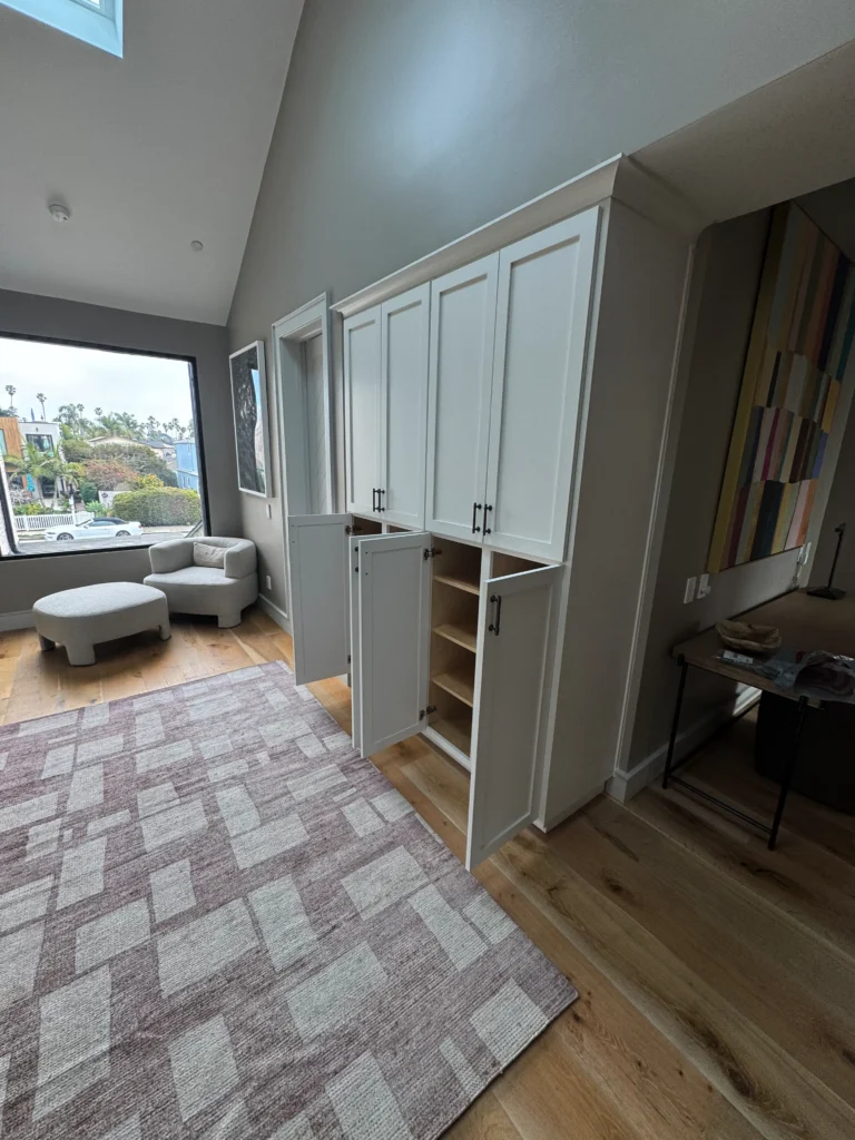 floor-to-ceiling white shaker style storage cabinets