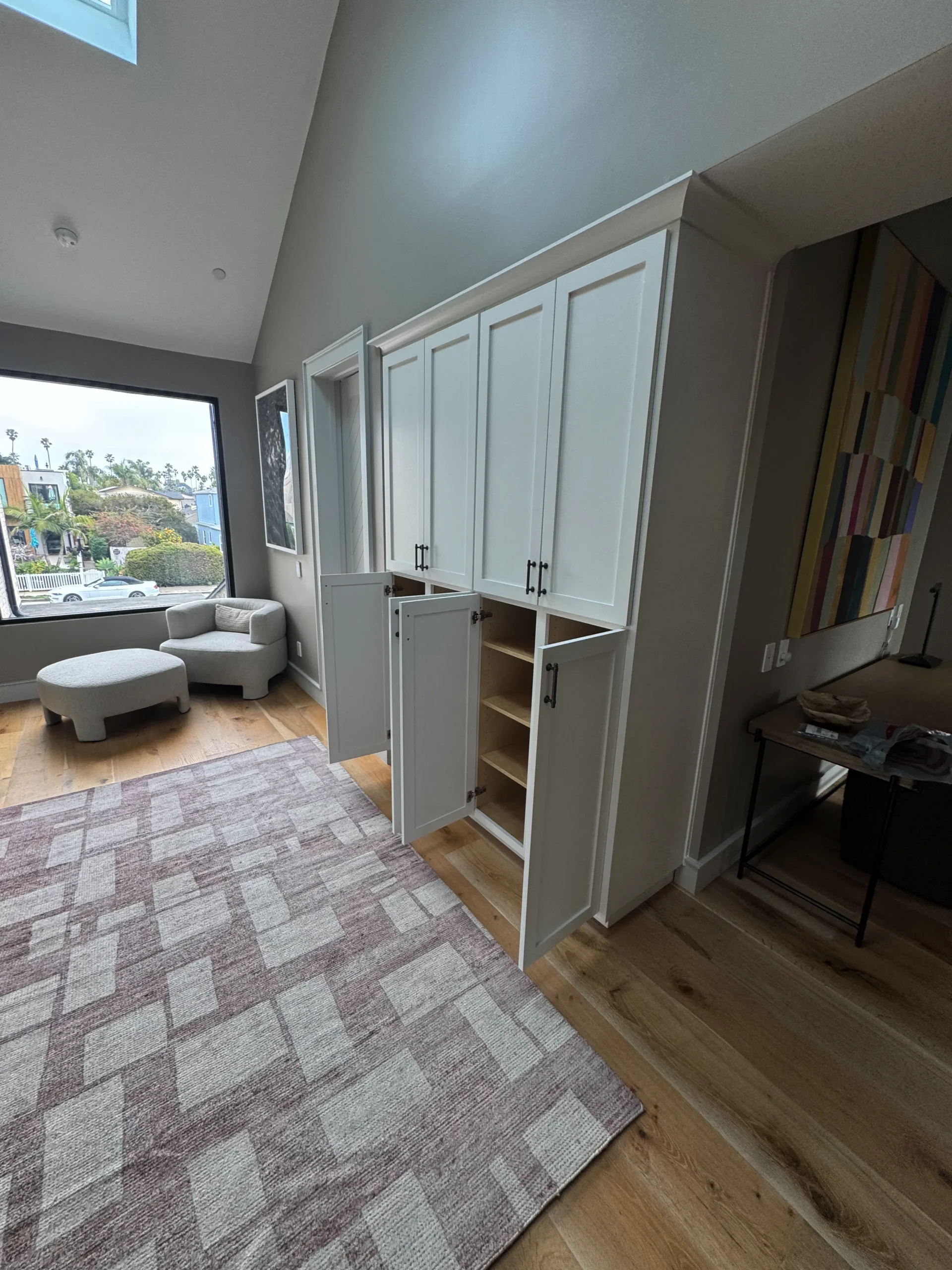 floor-to-ceiling white shaker style storage cabinets