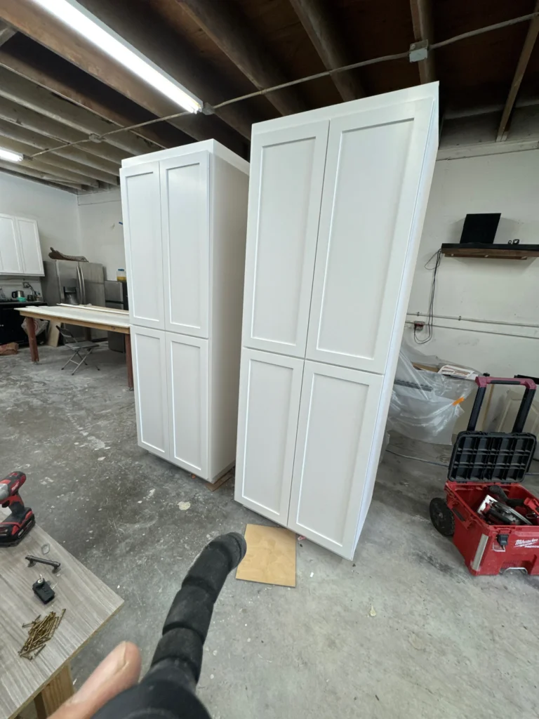 floor-to-ceiling white shaker style storage cabinets