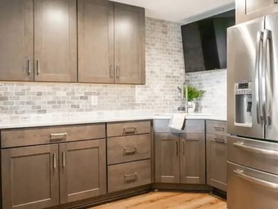 Expert applying paint to kitchen cabinet doors