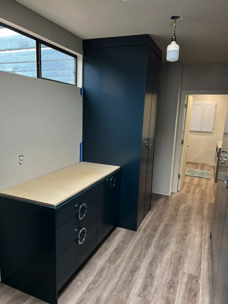 custom laundry room cabinets San Marcos with hidden washer dryer