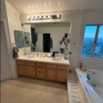 Dated oak cabinets with white tile countertop